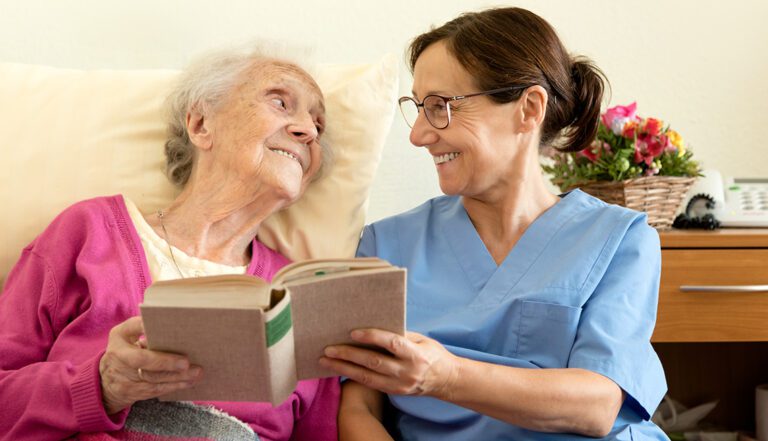 caregiver helping a senior reading book, respite care